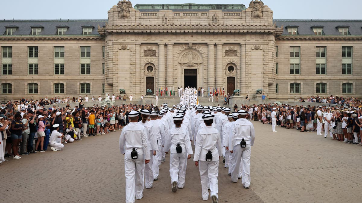 Incoming plebes (freshmen) march into Bancroft Hall after taking part in their Oath of Office Ceremony during Induction Day at the U.S. Naval Academy on June 29, 2023