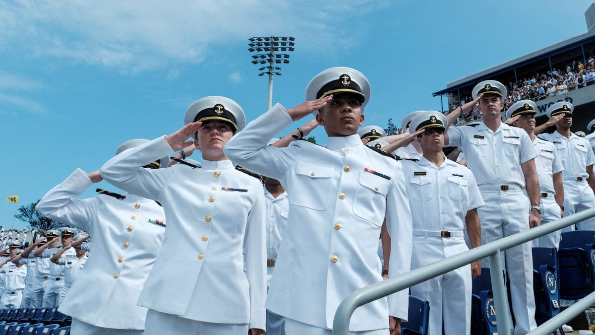 Midshipmen render a salute during the commissioning and graduation ceremony at the U.S. Naval Academy in Annapolis, Maryland, U.S., May 24, 2024.