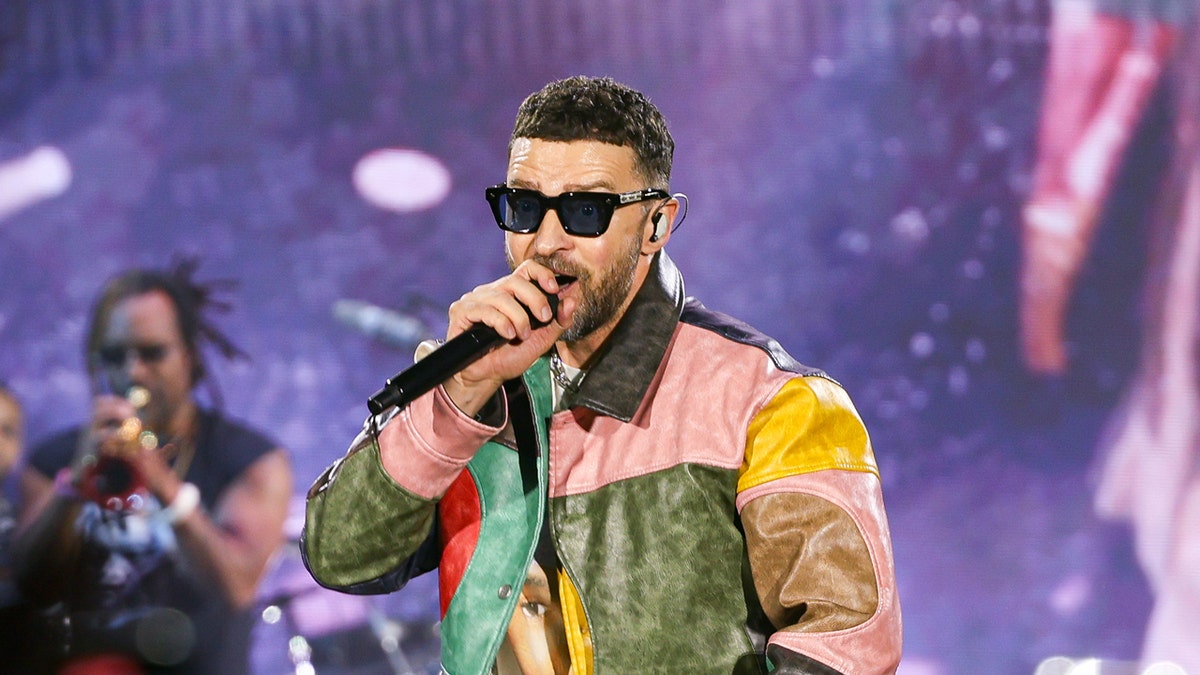 Justin Timberlake wearing a colorful jacket while performing on stage