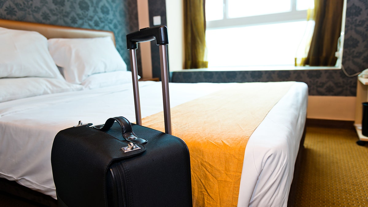 hotel room with suitcase standing