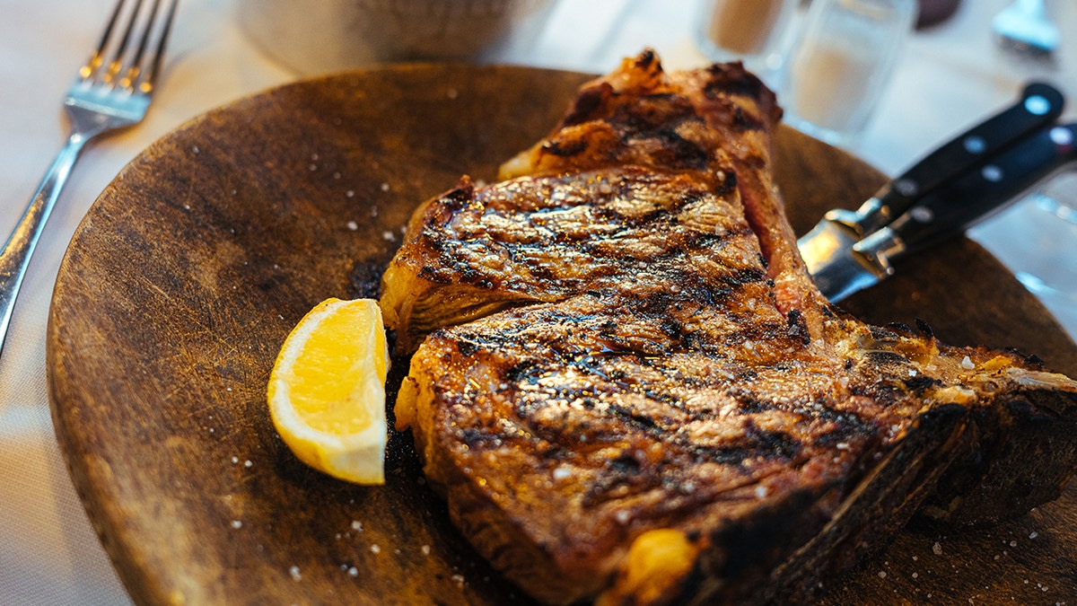 Close-up of t-bone steak with lemon